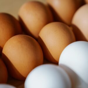 Close-up of brown and white eggs arranged on a surface, showcasing their texture and color.